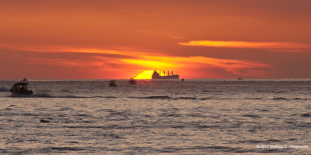 Sun Begins to Rise with Freighter. Photo by Mathew Hargreaves; copyright 2011, all rights reserved. Used with Permission.